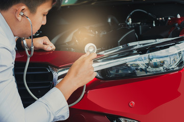 Asian man holding stethoscope car inspection Rubber tires car.Close up hand