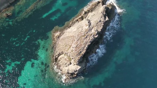 Flying over a big rock in Algaiarens in Menorca