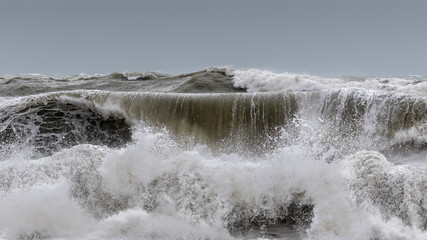 Large breakers and high waves roll towards the coast in eastern Spain near the city of Denia and overturn.