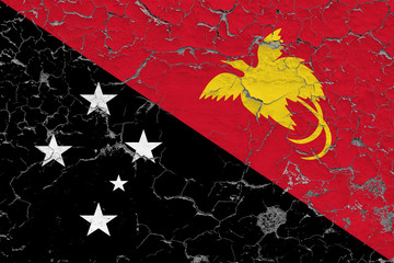 Flag of Papua New Guinea painted on cracked dirty wall. National pattern on vintage style surface.