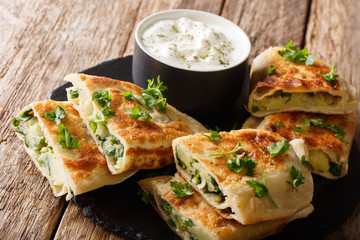 Traditional afghan friedflat bread bolani with potatoes, green onions and cilantro closeup....