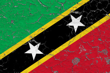 Flag of Saint Kitts And Nevis painted on cracked dirty wall. National pattern on vintage style surface.
