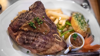 Meat Steak Served With French Fries And Baked Bread