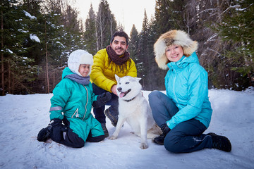 Fototapeta na wymiar Happy family walking in a winter forest