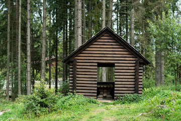 A small wooden house in the mountain forest.