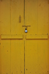 old yellow wooden door with lock