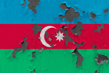 Close up grungy, damaged and weathered Azerbaijan flag on wall peeling off paint to see inside surface.