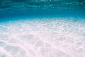 Tropical blue ocean with white sand underwater in Hawaii