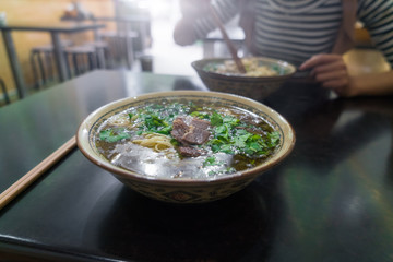 Bowl of real chinese noodles in real chinese restaurant in China