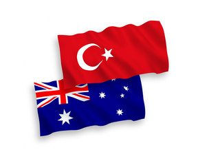 National vector fabric wave flags of Turkey and Australia isolated on white background. 1 to 2 proportion.