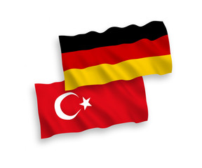 National vector fabric wave flags of Turkey and Germany isolated on white background. 1 to 2 proportion.