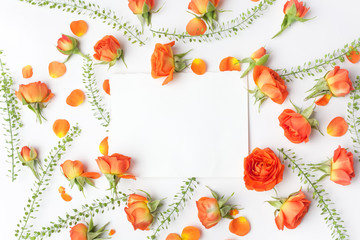 Framework from orange roses on white background. Flat lay. Top view