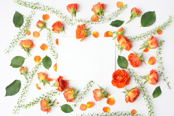 Framework from orange roses on white background. Flat lay. Top view