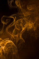 Gold smoke on black background.