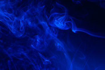 Blue smoke on black background.