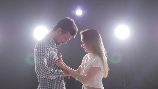 Concept of social dance and relationships. Young beautiful couple dancing sensual dance bachata.