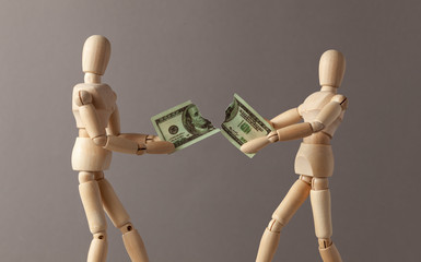 Two businessmen divide among themselves the profit ripped a bill of dollars 100 in half