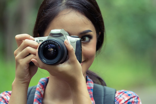 Asian woman taking photos with slr camera professional photography during her vacation 