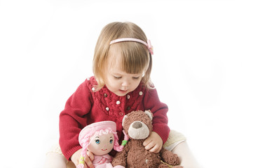 playing little girl. cute caucasian baby with bear and doll isolated on white background
