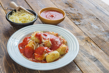 gnocchi stuffed with pesto with homemade tomato sauce and cheese