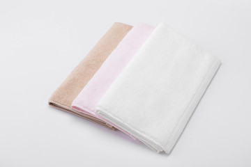 Stacked white, pink, apricot towels