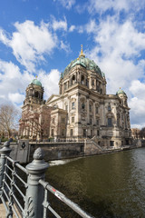Fototapeta premium Beautiful view of the historic landmark Berliner Dom (Berlin Cathedral) by the Spree River in Berlin, Germany, on a sunny day.