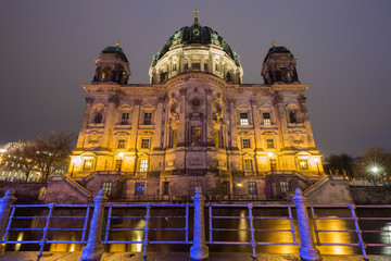 Beautiful view of illuminated Berliner Dom (Berlin Cathedral) by the Spree River in Berlin, Germany, at dusk.