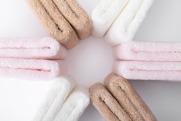 Stacked white, pink, apricot towels