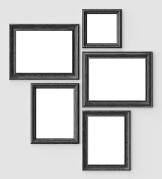 Black wood picture or photo frames on white wall with shadows with copy-space