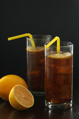 Glasses with cuba libre cocktail or cola with ice or cold tea with lemon