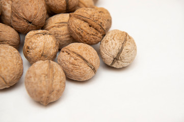 

walnut stands a lot on the table. greek nut and coffee beans on a bamboo mat, on a white...