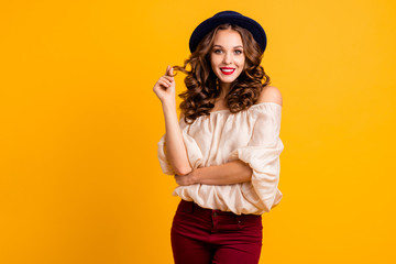 Portrait of her she nice-looking attractive fascinating winsome lovely pretty cheerful cheery girlish wavy-haired lady playing with curls isolated over bright vivid shine yellow background