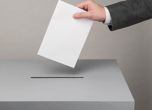 Gray ballot box. Presidential and parliamentary elections. The voter throws the ballot into the ballot box.