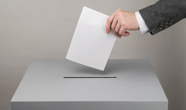 Gray ballot box. Presidential and parliamentary elections. The voter throws the ballot into the ballot box.