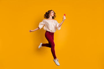 Fototapeta na wymiar Full length body size view portrait of her she nice attractive slim fit glad cheerful cheery wavy-haired lady using modern technology speed connection isolated on bright vivid shine yellow background