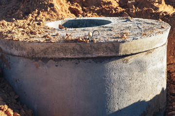 Concrete well at the construction site for water pipes