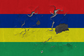 Close up grungy, damaged and weathered Mauritius flag on wall peeling off paint to see inside surface.