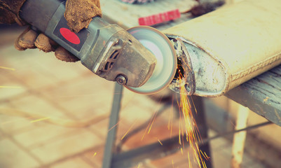 cut metal repair machine muffler. Selective focus.