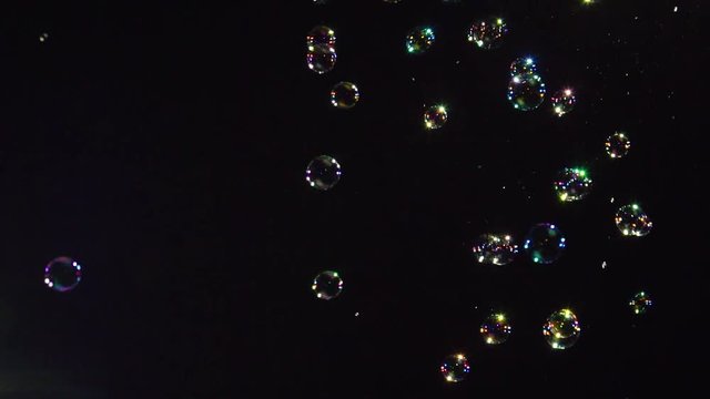 Soap bubbles slow motion on black background 