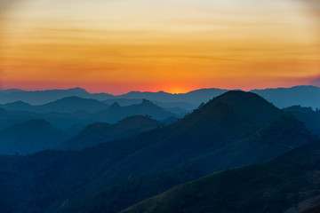 sunset over mountains in laos