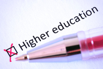 Obraz premium Questionnaire. Red pen and the inscription HIGHER EDUCATION with cross on the white paper