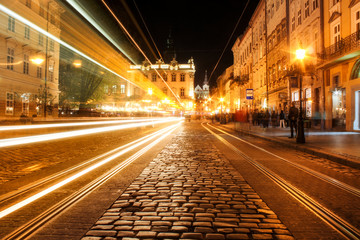 Lviv panorama at night. View of the night street of the European medieval city. Lviv Market square at night.  Concept  - travel, landmarks. FROZEN LIGHT FROM TRAM. Long exposure