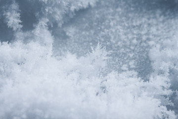 Frosty pattern on ice, winter season background, macro shot.