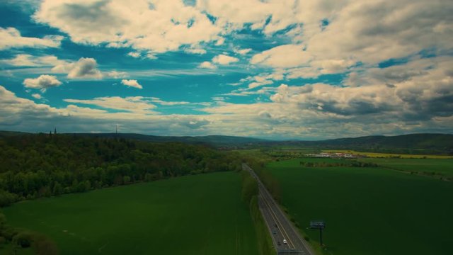 Aerial top down view on multilevel interchange overpass in Zbraslav showing afternoon traffic under sun and cloud