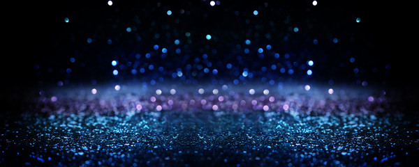 glitter vintage lights background. black silver and blue. de-focused