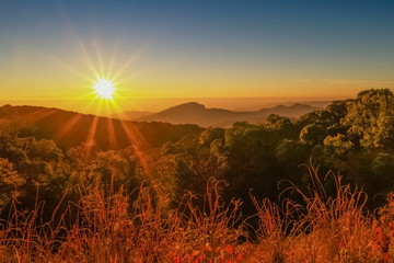 sunrise at Doi Inthanon National Park, mountain view morning of Doi Hua Suea top mountain around with soft fog with red sky background, Kew Mae Pan View Point, Chiang Mai, Thailand.