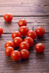 Fresh ripe garden tomatoes lying on wooden table. Side view with copy space.