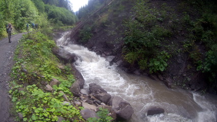 Fototapeta na wymiar Mountain river and waterfall in mountain forest
