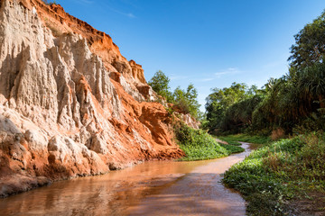 beautiful creek fairies with red and white sandstone in Mui Ne, Vietnam. The river flows in the...