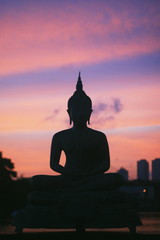 Buddha Statue silhouette on the sunset violet pink sky in Colombo